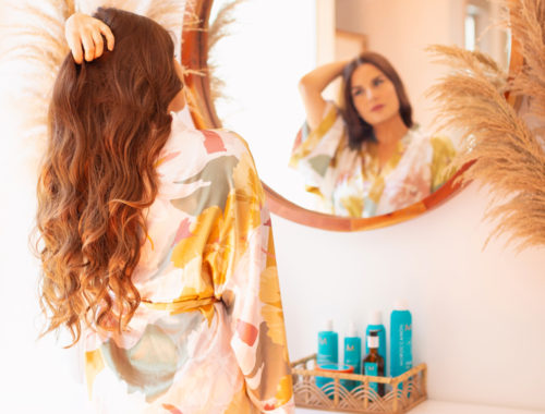 My Haircare Routine for Long Thick Colour Treated Hair | Brunette woman with long, thick wavy hair in a silk robe standing in front of a circular mirror in a sunny boho living room | MoroccanOil haircare routine | BeautySense review | Gentle Haircare Routine | Color-safe, sulphate free, phosphate free and paragon free haircare routine | JustineCelina haircare routine | JustineCelina Hair | Hair growth tips | Hair growth products | Long Hair Secrets | Calgary Beauty Blogger // JustineCelina.com
